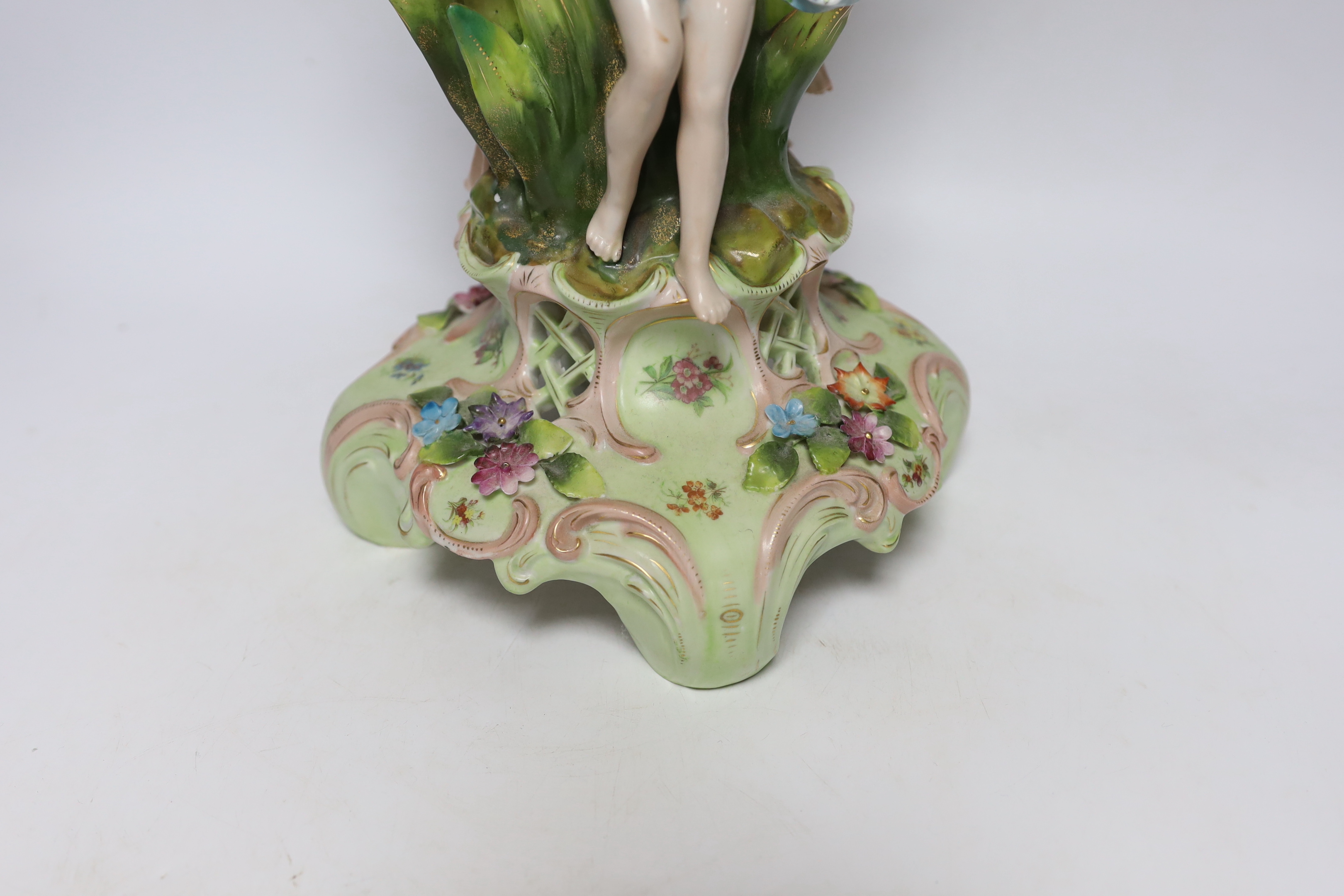 A Sitzendorf figural centrepiece, a smaller similar centrepiece and an English porcelain basket, tallest 54cm